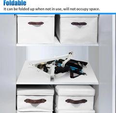 Foldable storage solution with white boxes and tools on a white surface.